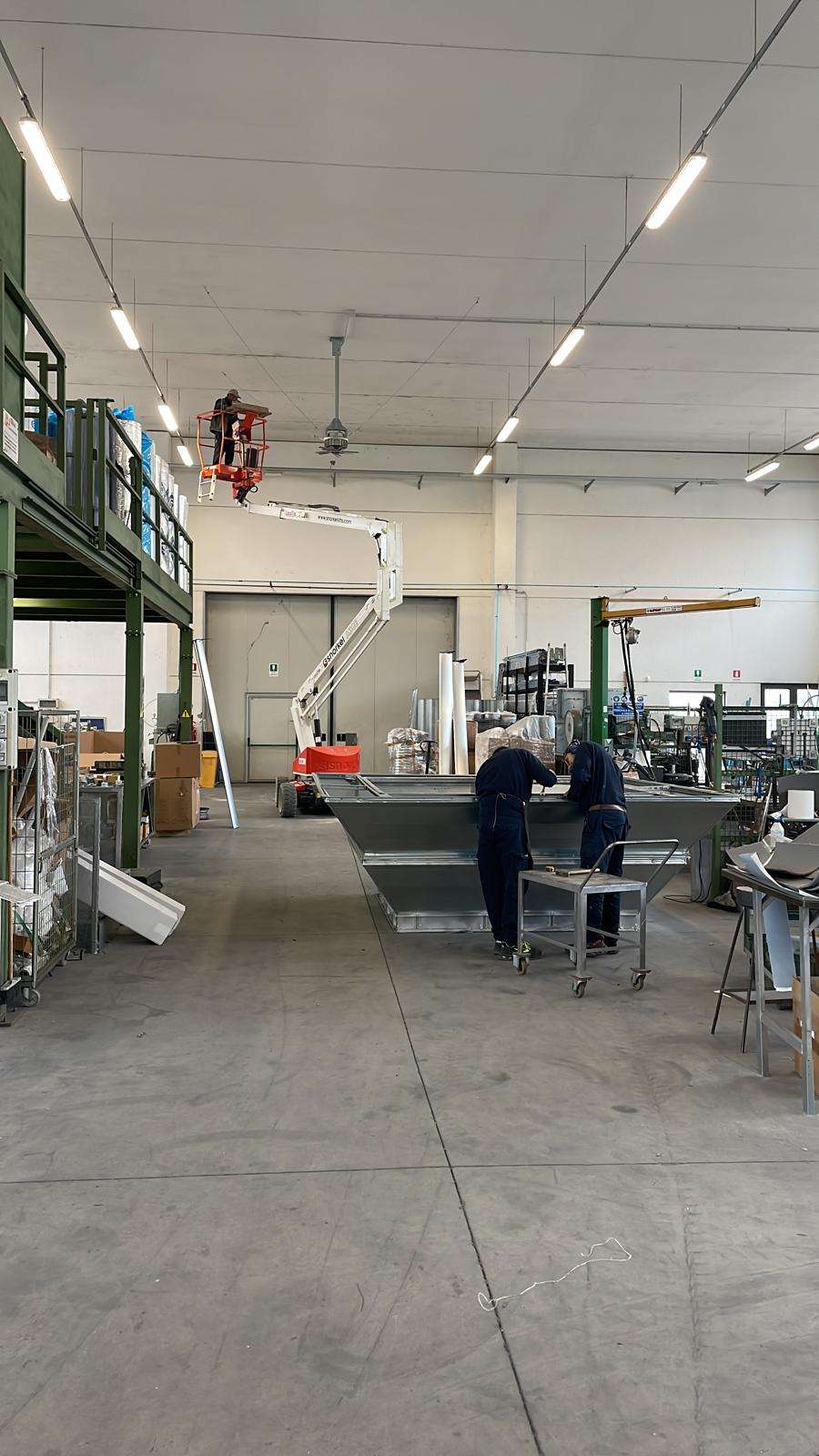 Warehouse fan installation with lift equipment